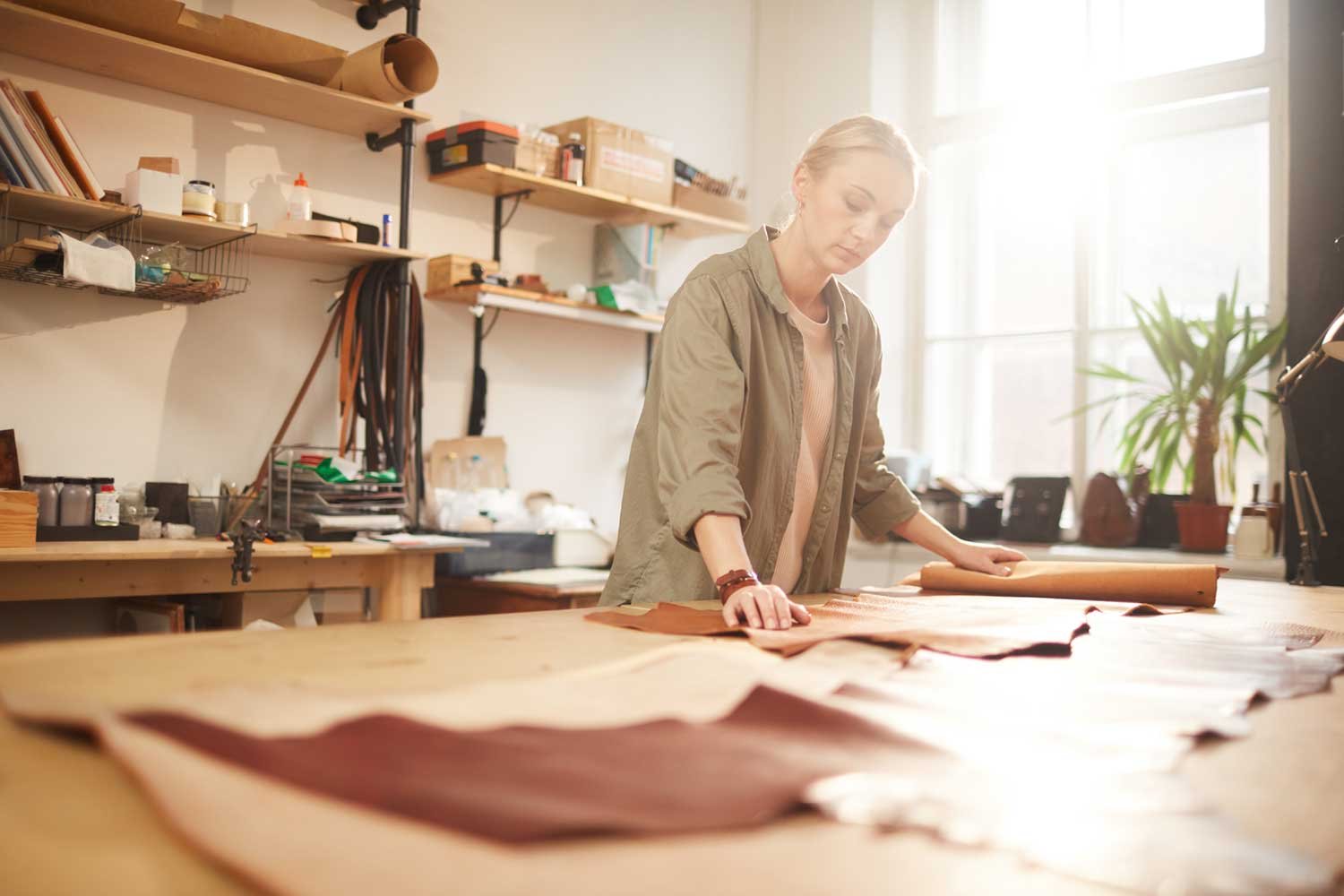 woman rolling out material for craft small